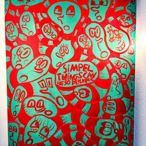 May include: Abstract artwork featuring teal figures on a red background. The figures display diverse expressions and are linked by red lines. A speech bubble contains the text "SIMPLE THINGS CAN BE SO BEAUTIFUL".