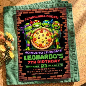 May include: A rectangular birthday invitation card featuring four cartoon turtles holding a large pizza. The text reads COWABUNGA DUDES! JOIN US TO CELEBRATE LEONARDO'S 7TH BIRTHDAY NOVEMBER 23 AT 4 TO 6 PM LEONARDO'S HOUSE 196 WILSON ST, HILLSBORO, KS.