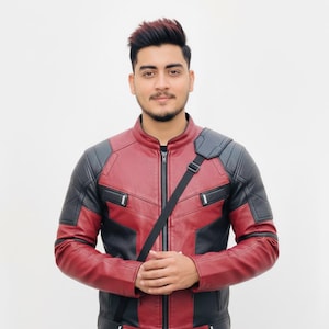 May include: A red and black leather jacket with a zip-up front and a stand-up collar. The jacket has black panels on the shoulders and sides, with a black strap across the body.