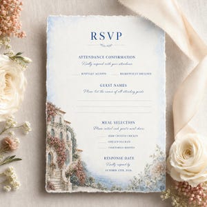 May include: A rectangular RSVP card with deckled edges featuring a watercolor illustration of a Mediterranean villa with pink flowers. The text includes RSVP, Attendance Confirmation, Guest Names, Meal Selection, and Response Date October 12th, 2026.