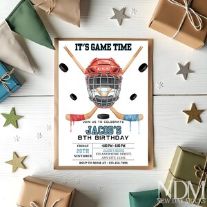 May include: A hockey-themed birthday invitation with a red helmet, crossed hockey sticks, and a black puck. The invitation reads "IT'S GAME TIME" and includes party details for Jacob's 8th birthday.