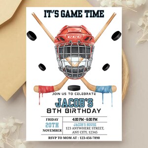 May include: A hockey-themed invitation with the text "IT'S GAME TIME" at the top. The design includes a red hockey helmet, crossed hockey sticks, and black pucks. The invitation is for Jacob's 8th birthday, with date, time, and location details.