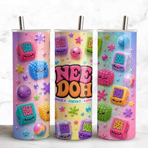 May include: Three cylindrical tumblers with metal straws featuring a colorful Nee Doh pattern. The design includes various squishy toy shapes, cubes, and spheres with smiling faces, scattered stars, and the text Nee Doh, Squeeze It, Stretch It, Squish.