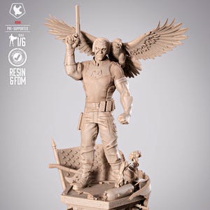 May include: A detailed, tan-colored statue of a superhero figure holding a gun and an eagle perched on his shoulder. The statue is on a base with a flag and other elements. The text "PRE-SUPPORTED" and "RESIN & FDM" is visible.