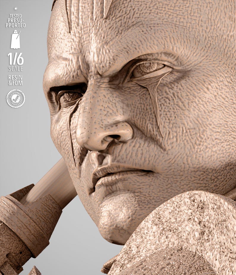 May include: A detailed, close-up of a sculpted bust of a stern-faced figure with a furrowed brow and a tear-like marking under the eye. The bust is a light beige color and features the text "1/6 SCALE RESIN & FDM".
