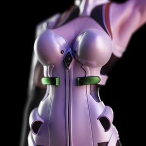 May include: A white, form-fitting bodysuit featuring a central vertical seam, a small metallic diamond-shaped accent at the chest, and two horizontal green rectangular panels at the waist. The garment has a smooth, structured, and molded appearance.