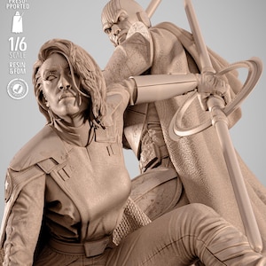 May include: A detailed, beige-colored resin statue depicting two figures in a dynamic pose. One figure is holding a weapon, while the other is in a defensive stance. The statue is 1/6 scale and includes the text "TESTED PRESUPPORTED", "1/6 SCALE", and "RESIN & FDM".