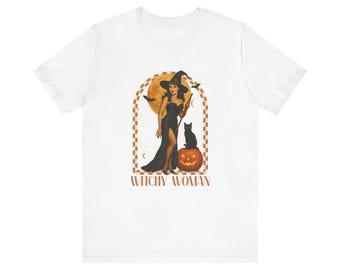May include: White t-shirt featuring a vintage-style illustration of a witch in a black dress, hat, and holding a staff, with a black cat and pumpkin. The text "Witchy Woman" is below the image.