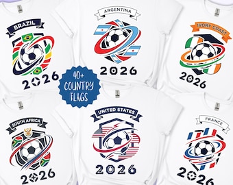 May include: White t-shirts featuring soccer ball designs with country flags and the year 2026. Flags include Brazil, Argentina, Ivory Coast, South Africa, United States, and France. The text "40+ COUNTRY FLAGS" is also present.