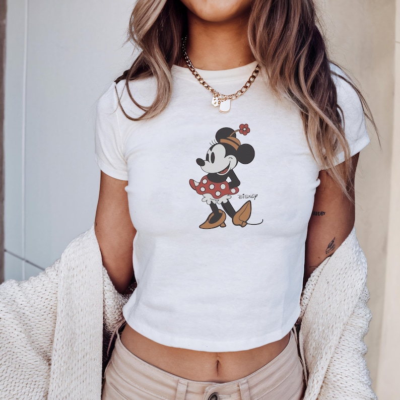 May include: A white ceramic mug with a black handle and the text "But First, Coffee" in a black, bold font. The mug is sitting on a white surface.