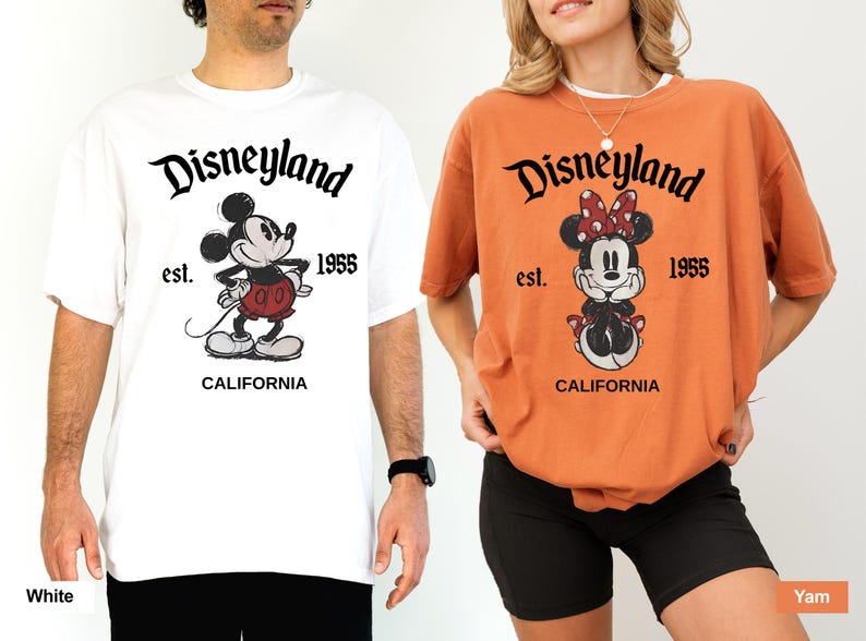 May include: Two t-shirts, one white and one orange, featuring the Disneyland logo and Mickey and Minnie Mouse. The white shirt has Mickey Mouse standing, while the orange shirt has Minnie Mouse sitting. Both shirts have "est. 1955" and "CALIFORNIA" printed below the characters.