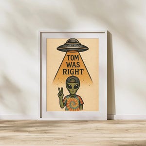 May include: Framed art print featuring an alien with a peace sign, wearing a backwards cap and tie-dye shirt. A UFO hovers above, with the text "TOM WAS RIGHT" in a retro style. The artwork is set against a tan background.