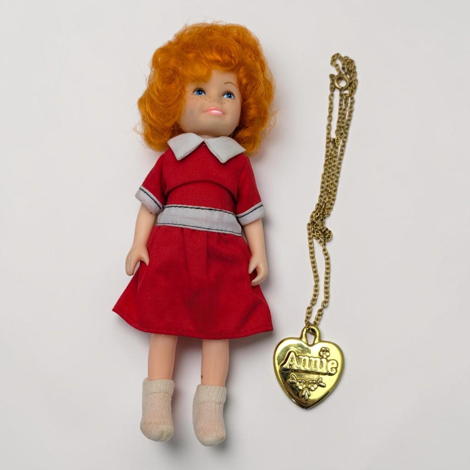 annie 1982 red dress Annie musical red dress with white collar displayed on mannequin,  showcasing iconic character costume and classic theatrical stage fashion  design Stock Photo