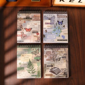 May include: Four spiral-bound notebooks featuring vintage-style collage covers with various printed elements including butterflies, flowers, ferns, a typewriter, newspaper clippings, and text such as Retro Time Machine, Dexter Cigar, and Curiosity.
