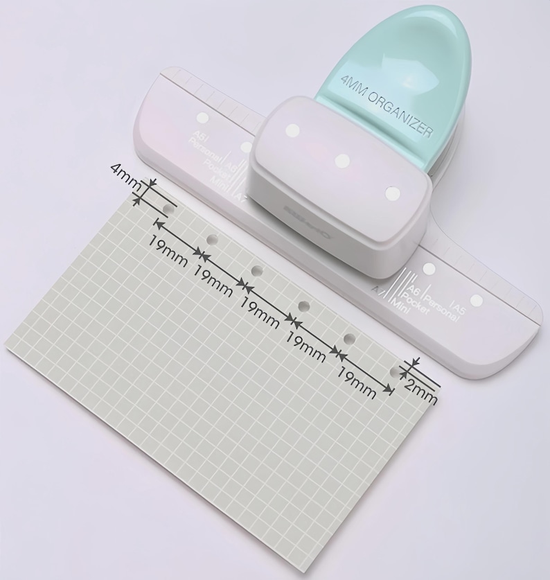 May include: A white and mint green 4mm organizer hole punch with a matching ruler guide. A gray grid paper shows measurements of 19mm and 4mm. The punch is labeled "4MM ORGANIZER".