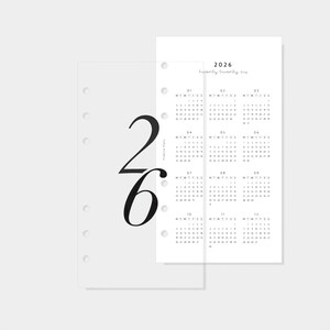 May include: A minimalist planner insert for 2026. The design features a white paper with a calendar layout and the year printed at the top. A transparent overlay with the large numbers "26" is on the left.