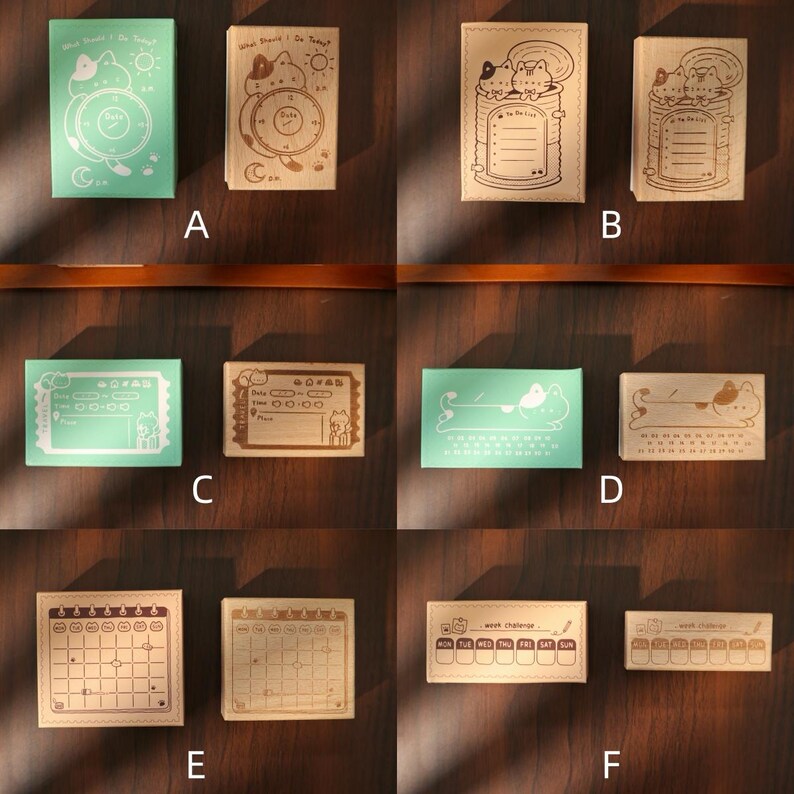 May include: A collection of wooden stamps with various designs, including cats, clocks, and calendars. The stamps are in different shapes and sizes, with some featuring text like "What Should I Do Today?" and "Week Challenge". The color palette includes shades of green and brown.