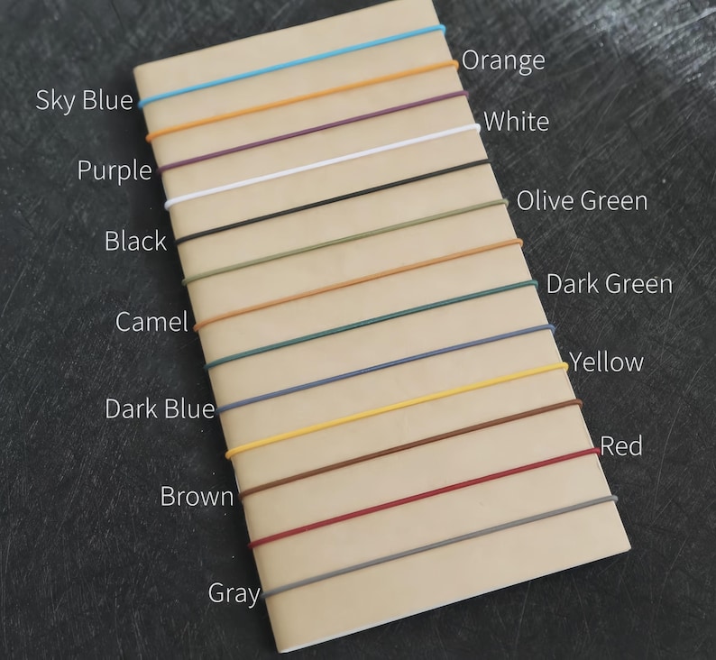 May include: A notebook with various colored cords attached. Colors include sky blue, orange, purple, white, black, olive green, camel, dark green, dark blue, yellow, brown, red, and gray. Text labels each color.