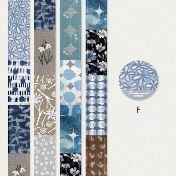 May include: A selection of patterned washi tapes in blue, grey, and brown. Designs include , geometric, and abstract patterns. A round sticker with a  design and the letter "F" is also visible.
