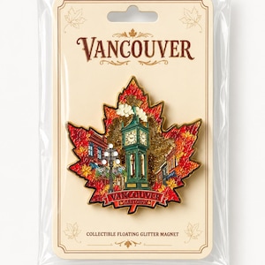 May include: A maple leaf-shaped magnet featuring a detailed illustration of the Gastown Steam Clock in Vancouver, surrounded by red and orange autumn leaves and gold glitter. The magnet is mounted on a card labeled Vancouver and Collectible Floating Glitter Magnet.