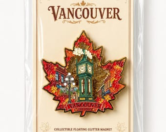 May include: A maple leaf-shaped magnet featuring a detailed illustration of the Gastown Steam Clock in Vancouver, surrounded by red and orange autumn leaves and gold glitter. The magnet is mounted on a card labelled Vancouver and Collectible Floating Glitter Magnet.