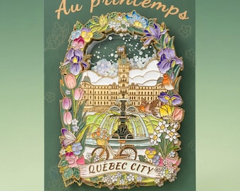 May include: A decorative pin featuring a colourful illustration of Quebec City, with a floral border and the words "Au printemps" and "Quebec City". The pin includes a bicycle, fountain, and building.