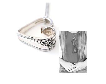 May include: A silver heart-shaped pendant necklace made from a vintage spoon. The pendant has a floral design and is attached to a silver chain.