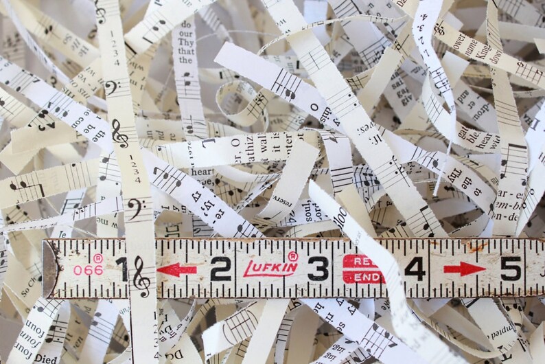 Shredded paper made from old hymnals. The paper is a mix of ivory and cream colors.