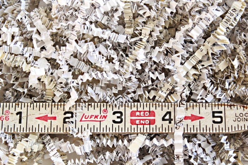Shredded paper made from old hymnals. The paper is a mix of ivory and cream colors.