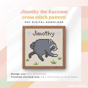 May include: A cross stitch pattern titled Jimothy the Raccoon PDF digital download. The design features a grey raccoon, the name Jimothy, and two light blue hearts. The finished stitched size is 9.65 x 9.65 cm on 14-ct fabric.