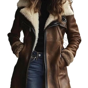 May include: A brown leather coat with a cream-colored shearling collar and cuffs. The coat has a zip closure, two front pockets, and a black trim. The model is wearing blue jeans and a black top.
