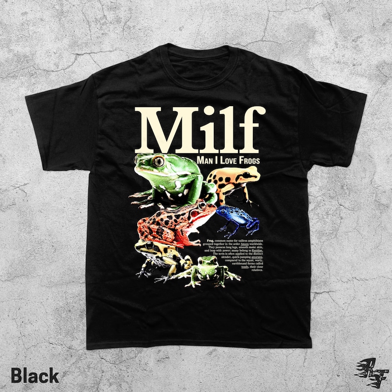 May include: Black t-shirt with the text "MILF: Man I Love Frogs" in a bold, cream-colored font. The shirt features a colorful graphic of various frog species. The word "Black" is printed at the bottom left.