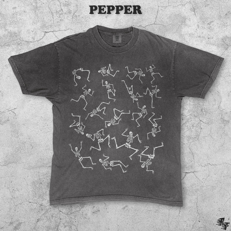 May include: Dark gray t-shirt with a crew neck and short sleeves. The shirt features a repeating white skeleton graphic. The word "PEPPER" is printed in white at the top of the image. The shirt has a vintage, worn look.
