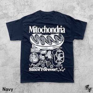 May include: Navy blue t-shirt with a white graphic design featuring the word "Mitochondria" and various illustrations related to cell biology. The text "Powering life Since Forever!" is also included.