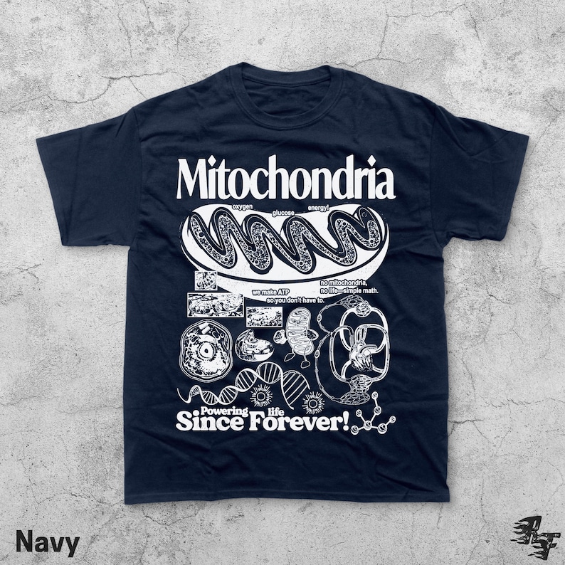 May include: Navy blue t-shirt with a white graphic design featuring the word "Mitochondria" and various illustrations related to cell biology. The text "Powering life Since Forever!" is also included.