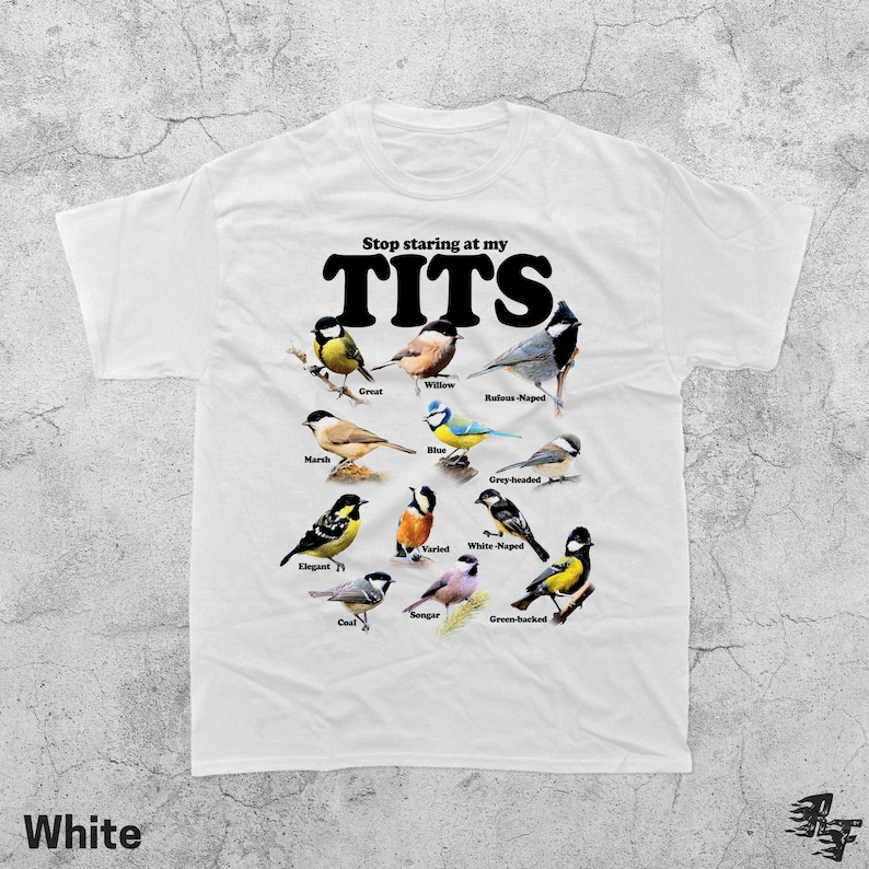 May include: White t-shirt featuring the phrase "Stop staring at my TITS" in black, accompanied by illustrations of different bird species. The word "White" is printed at the bottom left of the shirt.