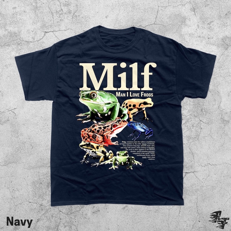 May include: Navy blue t-shirt featuring the word "Milf" above the phrase "Man I Love Frogs" and a collage of colorful frog illustrations. The shirt includes a detailed description of frogs.