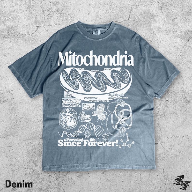 May include: Denim-colored t-shirt with a white graphic design featuring the word "Mitochondria" and related scientific illustrations. The shirt also includes the text "Powering life Since Forever!"
