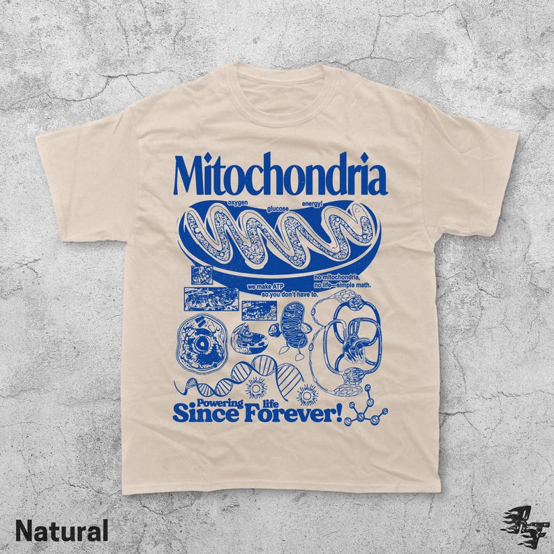 May include: A natural-colored t-shirt with a blue graphic design featuring the word "Mitochondria" and related scientific illustrations. The text "Powering life Since Forever!" is also included in the design.