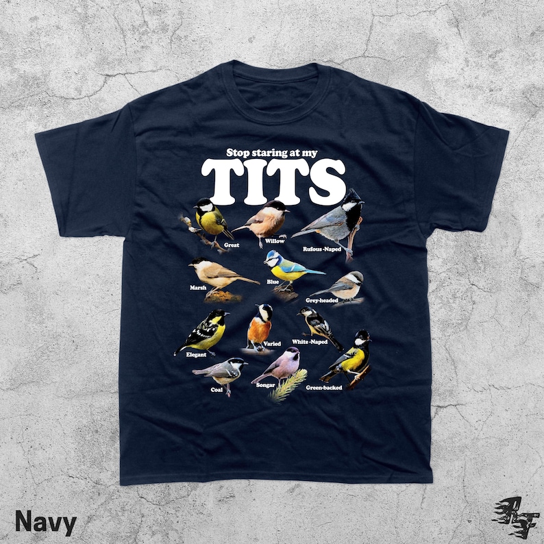 May include: Navy blue t-shirt with the text "Stop staring at my TITS" in white. The shirt features illustrations of various bird species, each labeled with their common names. The word "Navy" is printed at the bottom.