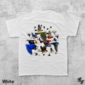 May include: White t-shirt featuring a colorful illustration of various bird species in flight. The design includes detailed depictions of different birds with their names, set against a white background. The word "White" is printed at the bottom.