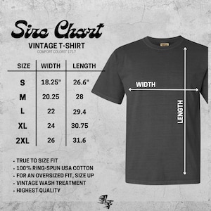 May include: A charcoal gray vintage t-shirt with a size chart. The chart lists sizes S to 2XL, with width and length measurements in inches. The shirt is made of 100% ring-spun USA cotton and has a vintage wash treatment.
