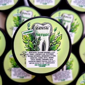 May include: A round container of peppermint toothpaste featuring a green label with a tooth illustration and the text Brush With Nature. The label lists ingredients including calcium carbonate, bentonite clay, and herbs, with a 60ml volume label.