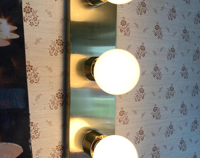 Antique Brass Three light wall lamp plug in style.