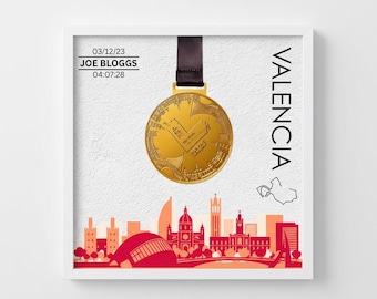 May include: Framed print featuring a gold medal suspended by a black ribbon. The medal is inscribed with "42K" and other text. The print includes the name "JOE BLOGGS" and the time "04:07:28". The word "VALENCIA" is printed vertically.