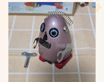 Vintage Wind-Up Tin Robot: Retro Desk Toy with Clown Charm