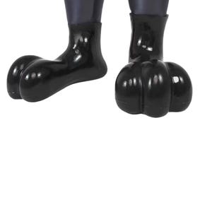 May include: Close-up of two black, glossy, cartoon-like feet. The feet have large, rounded toes and are attached to dark, cylindrical legs. The image is set against a plain white background.
