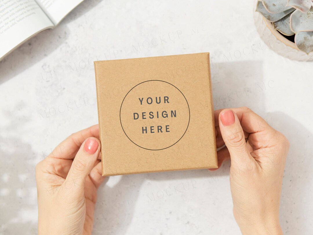 Kraft Brown Jewelry Box Packaging Mockup With Hands and Plants. Dappled