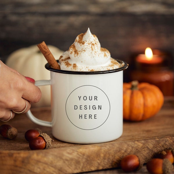 Thanksgiving halloween fall mock ups. Enamel camping mug with hand model. Cream and cinnamon. Adventure coffee cup, black rim, cosy styling.