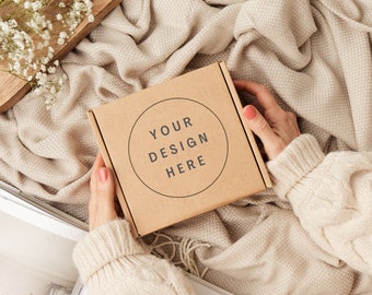 Gift box packaging mockup with hands. Kraft brown postage box mockup.